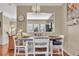 Cozy dining area featuring hardwood floors, a chandelier, and pass-through to the kitchen at 113 Brianna Way, Woodstock, GA 30188
