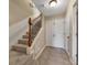 View of a staircase with carpeted steps, neutral walls, and tiled entryway at 113 Brianna Way, Woodstock, GA 30188