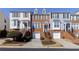 Three-story brick townhomes with individual garages and well-manicured front yards at 113 Brianna Way, Woodstock, GA 30188