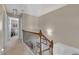 Second floor hallway featuring wood and wrought iron railing and carpeted floor at 113 Brianna Way, Woodstock, GA 30188