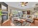 Comfortable living room featuring a fireplace, hardwood floors, and a serene view of the backyard at 113 Brianna Way, Woodstock, GA 30188