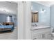 Bathroom with white vanity, chrome faucet, and a glimpse into the blue painted bedroom at 150 Forest Ridge Ct, Lawrenceville, GA 30046