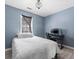 Bedroom with blue walls, wood floors, a window and a computer desk at 150 Forest Ridge Ct, Lawrenceville, GA 30046