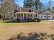Charming home features a cozy front porch and detached two-car garage at 150 Forest Ridge Ct, Lawrenceville, GA 30046