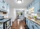 Spacious kitchen with blue cabinets and granite counters, seamlessly connecting to the dining area, perfect for entertaining at 150 Forest Ridge Ct, Lawrenceville, GA 30046