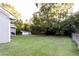 Large grassy backyard with a shed in the distance, partially surrounded by a chainlink fence at 391 Oak Dr, Social Circle, GA 30025
