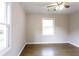 Bedroom with hardwood floors, two windows providing lots of natural light, and neutral walls at 391 Oak Dr, Social Circle, GA 30025