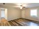 Bedroom featuring durable gray-toned laminate flooring, ceiling fan, and ample natural light at 391 Oak Dr, Social Circle, GA 30025