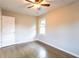 Bedroom with hardwood floors, a ceiling fan, and bright natural light at 391 Oak Dr, Social Circle, GA 30025