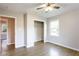 Bright bedroom with hardwood floors, ceiling fan, closet with a rod, and natural light from window at 391 Oak Dr, Social Circle, GA 30025