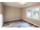 Bright bedroom featuring durable gray-toned laminate flooring and a large window at 391 Oak Dr, Social Circle, GA 30025