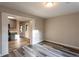 Bright dining area featuring durable gray-toned laminate flooring and views into kitchen at 391 Oak Dr, Social Circle, GA 30025