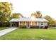 Charming single-story home featuring a covered carport and a well-manicured lawn at 391 Oak Dr, Social Circle, GA 30025