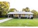 Charming single-story home featuring a carport, manicured lawn, and lush landscaping at 391 Oak Dr, Social Circle, GA 30025
