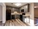 Well-lit kitchen with gray cabinets, modern appliances and durable gray-toned laminate flooring at 391 Oak Dr, Social Circle, GA 30025