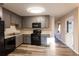 Updated kitchen featuring gray cabinets, modern appliances, and durable gray-toned laminate flooring at 391 Oak Dr, Social Circle, GA 30025