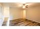 Open living area with durable gray-toned laminate flooring, ceiling fan, and views into other rooms at 391 Oak Dr, Social Circle, GA 30025