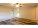 A well-lit living room with wood-look flooring and a ceiling fan at 391 Oak Dr, Social Circle, GA 30025