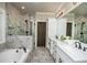 Bright bathroom featuring a soaking tub, glass-enclosed shower with marble tile, and double sink vanity at 105 Crown Ln, Woodstock, GA 30188