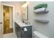 Elegant bathroom featuring a vanity with white countertops, stylish mirror, and decorative floating shelves at 105 Crown Ln, Woodstock, GA 30188