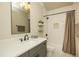Updated bathroom with gray vanity, quartz countertop, updated light fixture, and shower-tub combo at 105 Crown Ln, Woodstock, GA 30188