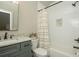 Charming bathroom features granite counters, gray cabinets, and shower over tub with white tile surround at 105 Crown Ln, Woodstock, GA 30188