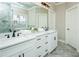 Bathroom with double vanity sinks, a large mirror, and a glass shower door at 105 Crown Ln, Woodstock, GA 30188