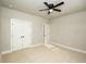 Neutral bedroom featuring a ceiling fan, carpet, and double-door closet for a clean, simple design at 105 Crown Ln, Woodstock, GA 30188