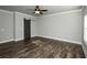 Bedroom with hardwood floors, ample natural light and a sliding barn door leading to the en suite bath at 105 Crown Ln, Woodstock, GA 30188
