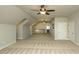 Spacious bonus room featuring neutral carpet, ceiling fans, and access to additional areas of the house at 105 Crown Ln, Woodstock, GA 30188