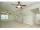 A carpeted bonus room features high ceilings, windows for natural light, and a ceiling fan at 105 Crown Ln, Woodstock, GA 30188