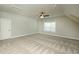 Bonus room with carpeting, neutral walls, a window providing natural light, and a ceiling fan at 105 Crown Ln, Woodstock, GA 30188