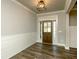 Welcoming entryway with stylish wood-look flooring and a well-lit front door at 105 Crown Ln, Woodstock, GA 30188