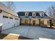 Stunning modern farmhouse with a three-car garage and inviting covered porch and craftsman-style details at 105 Crown Ln, Woodstock, GA 30188