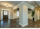 Open-concept foyer featuring hardwood floors, decorative columns, and natural light, showcasing architectural details at 105 Crown Ln, Woodstock, GA 30188