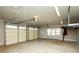 Expansive garage with multiple doors, shelving, and natural light is ideal for storage and hobbies at 105 Crown Ln, Woodstock, GA 30188