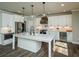 Gourmet kitchen with white cabinetry, stainless steel appliances, and center island perfect for entertaining at 105 Crown Ln, Woodstock, GA 30188