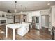 Stylish kitchen featuring a center island, stainless steel appliances, and seamless flow to the living area at 105 Crown Ln, Woodstock, GA 30188