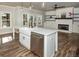 Bright kitchen with island, stainless steel appliances and a view into the open concept living space at 105 Crown Ln, Woodstock, GA 30188