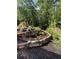 Beautifully terraced landscaping with stone walls and mature plants, surrounded by trees at 105 Crown Ln, Woodstock, GA 30188