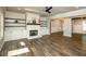 Cozy living room with a fireplace, built-in shelving, and wood-look floors at 105 Crown Ln, Woodstock, GA 30188