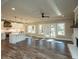 Open living space featuring white cabinets, a large island and stainless appliances adjacent to the fireplace at 105 Crown Ln, Woodstock, GA 30188