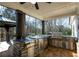 Luxurious covered outdoor kitchen with stainless steel appliances and stone accents at 105 Crown Ln, Woodstock, GA 30188