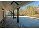 Spacious covered patio with brick flooring, dark wood posts and ceiling fans at 105 Crown Ln, Woodstock, GA 30188