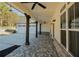 Covered patio featuring brick flooring, ceiling fans, dark wood posts, and views of the property at 105 Crown Ln, Woodstock, GA 30188