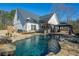 Gorgeous backyard featuring a freeform pool, gazebo, and outdoor kitchen at 105 Crown Ln, Woodstock, GA 30188