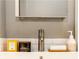 Modern bathroom sink featuring soap, towel and various perfumes at 32 Peachtree Nw St # 1105, Atlanta, GA 30303
