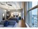Bedroom with comfortable bed, city views from large windows, and seating area at 32 Peachtree Nw St # 1105, Atlanta, GA 30303