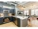 Modern kitchen featuring stainless steel appliances, dark cabinets, and a breakfast bar with seating at 32 Peachtree Nw St # 1105, Atlanta, GA 30303