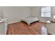 Simple bedroom with hardwood floors, a bed, and natural light from a window, creating a cozy atmosphere at 6700 Roswell Rd # 24E, Atlanta, GA 30328